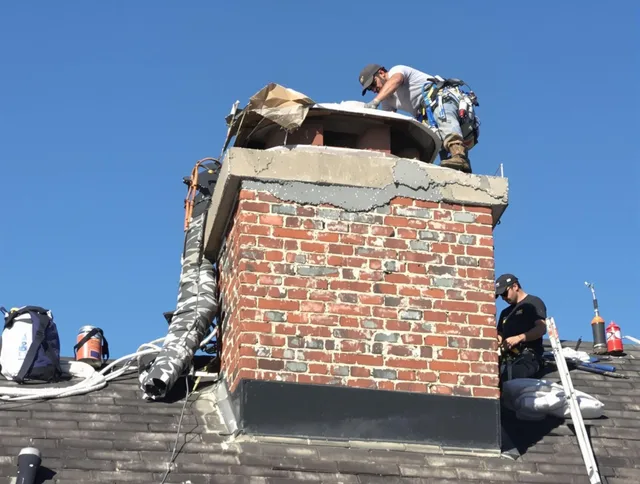 Bridgeport Chimney Sweep installing a custom chimney crown in Bridgeport, CT