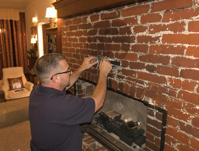 Bridgeport Chimney Sweep expert fixing a fireplace in Bridgeport, CT
